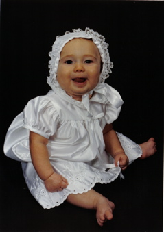 Domino, serious in a green sweatsuit with a white background